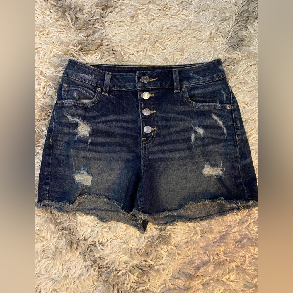 High rise, distressed, button fly jean shorts. Darker wash.